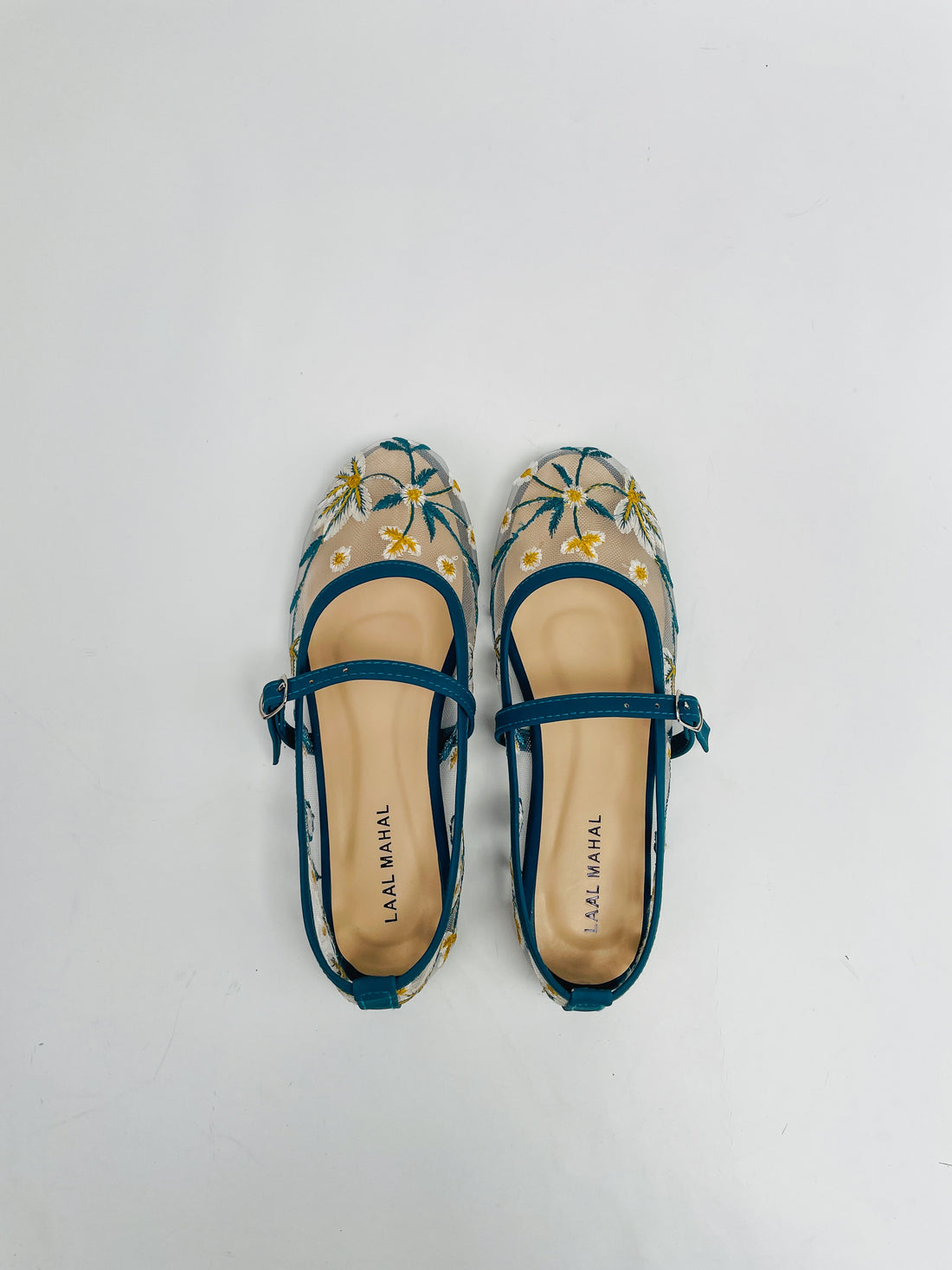 Zinc embroidered ballerinas worn on a white background