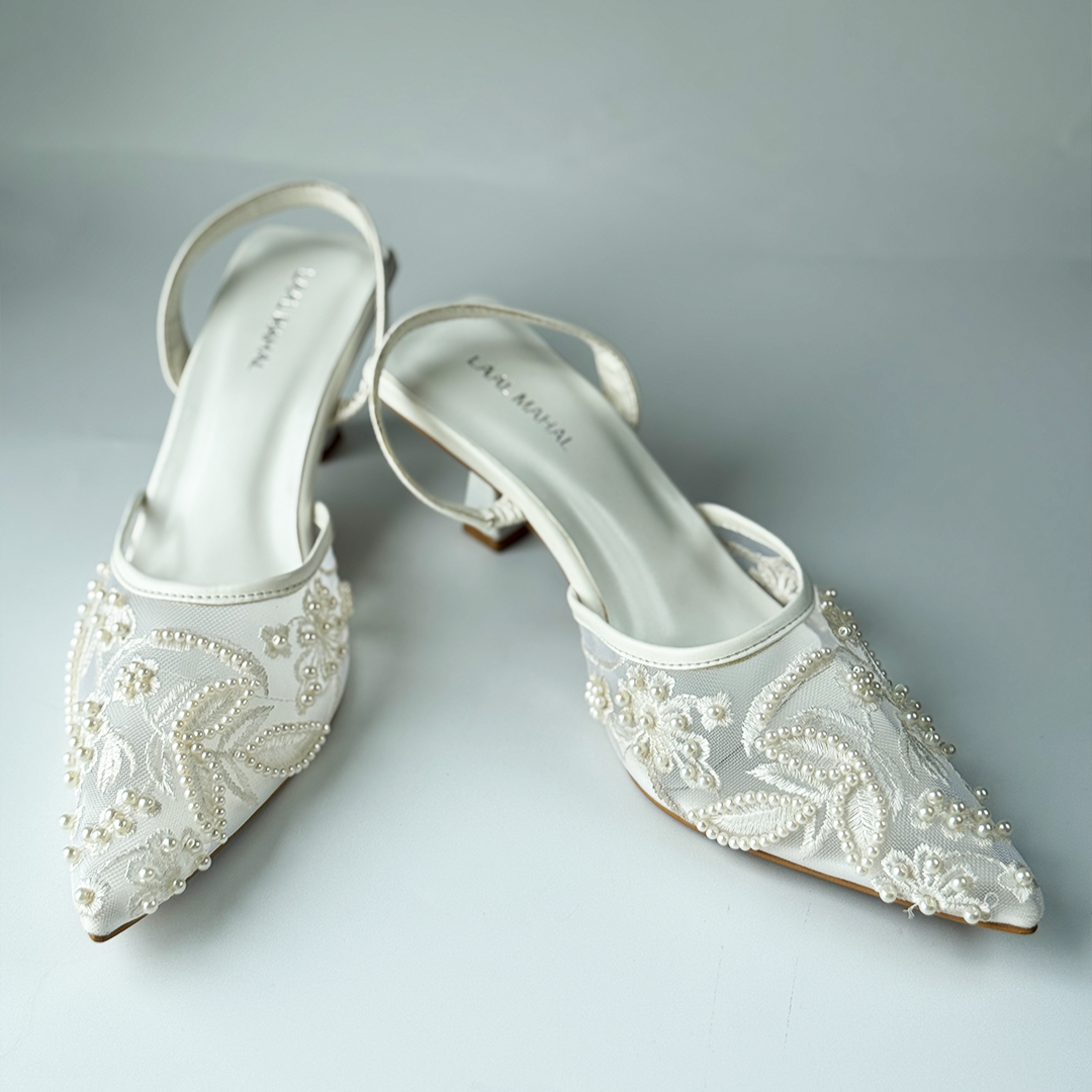 White mesh heels with a pointed toe, finished with fine embroidery and pearl embellishments.