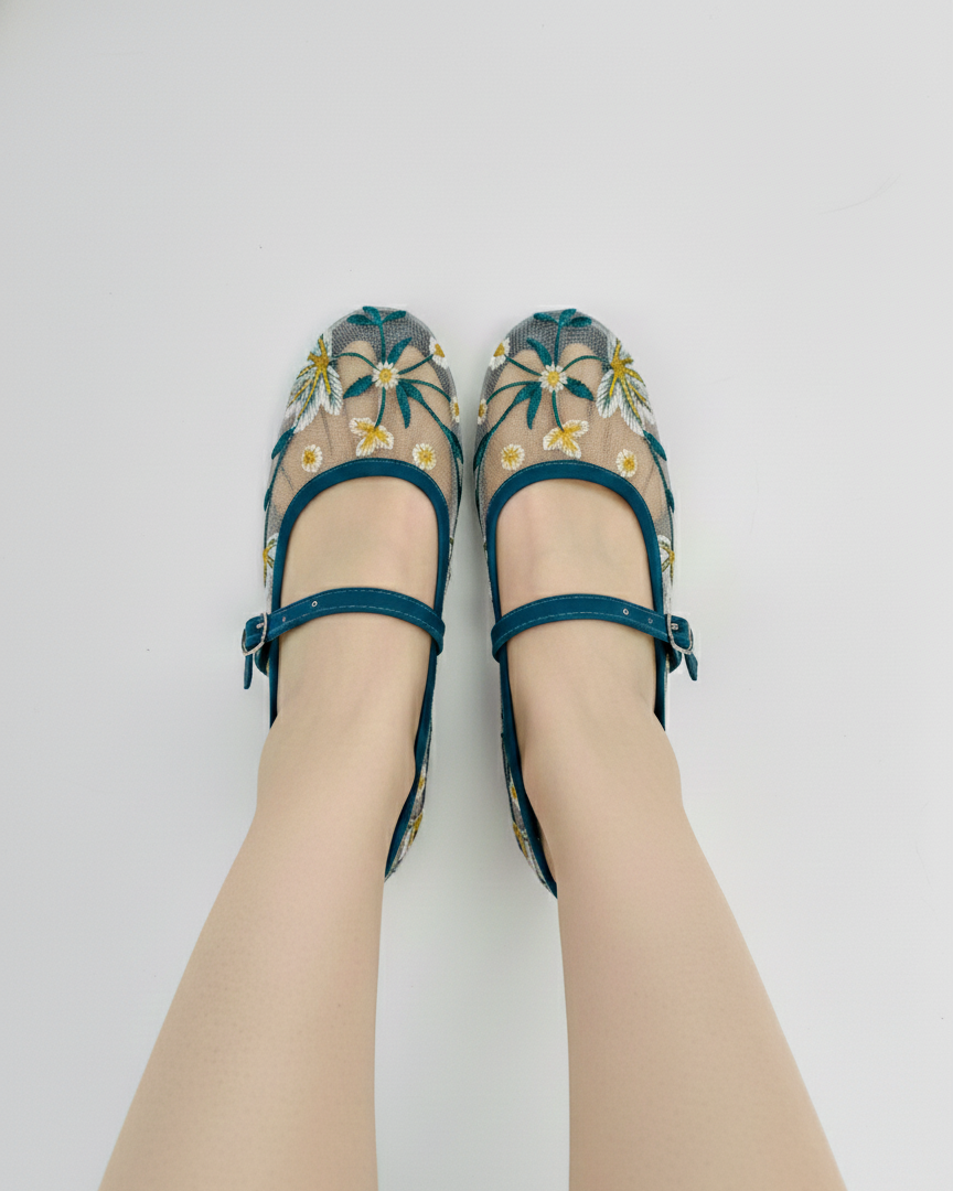 Zinc embroidered ballerinas worn on a white background