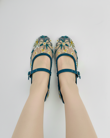 Zinc embroidered ballerinas worn on a white background