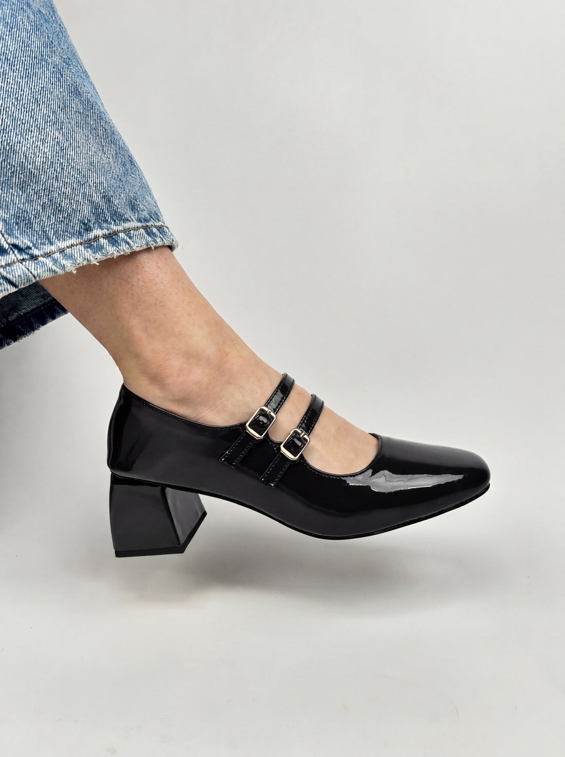 Black mary jane block heels worn with cream skirt Pakistan — Laal Mahal