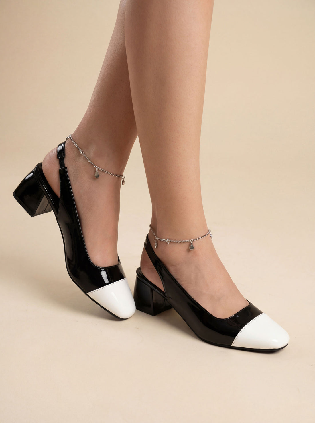 Black and white slingback block heels worn with black skirt Pakistan — Laal Mahal
