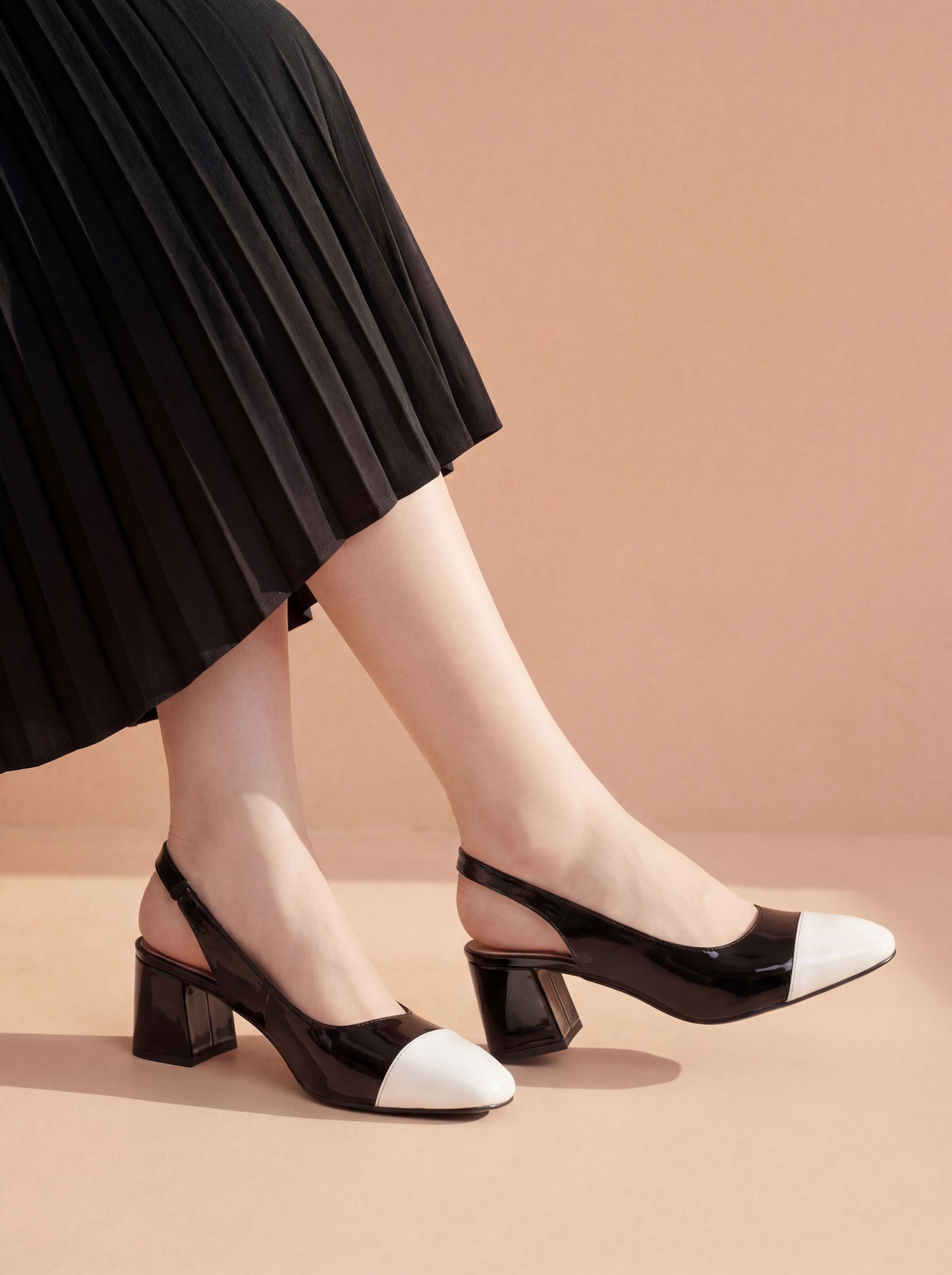 Black and white slingback block heels worn with black skirt Pakistan — Laal Mahal