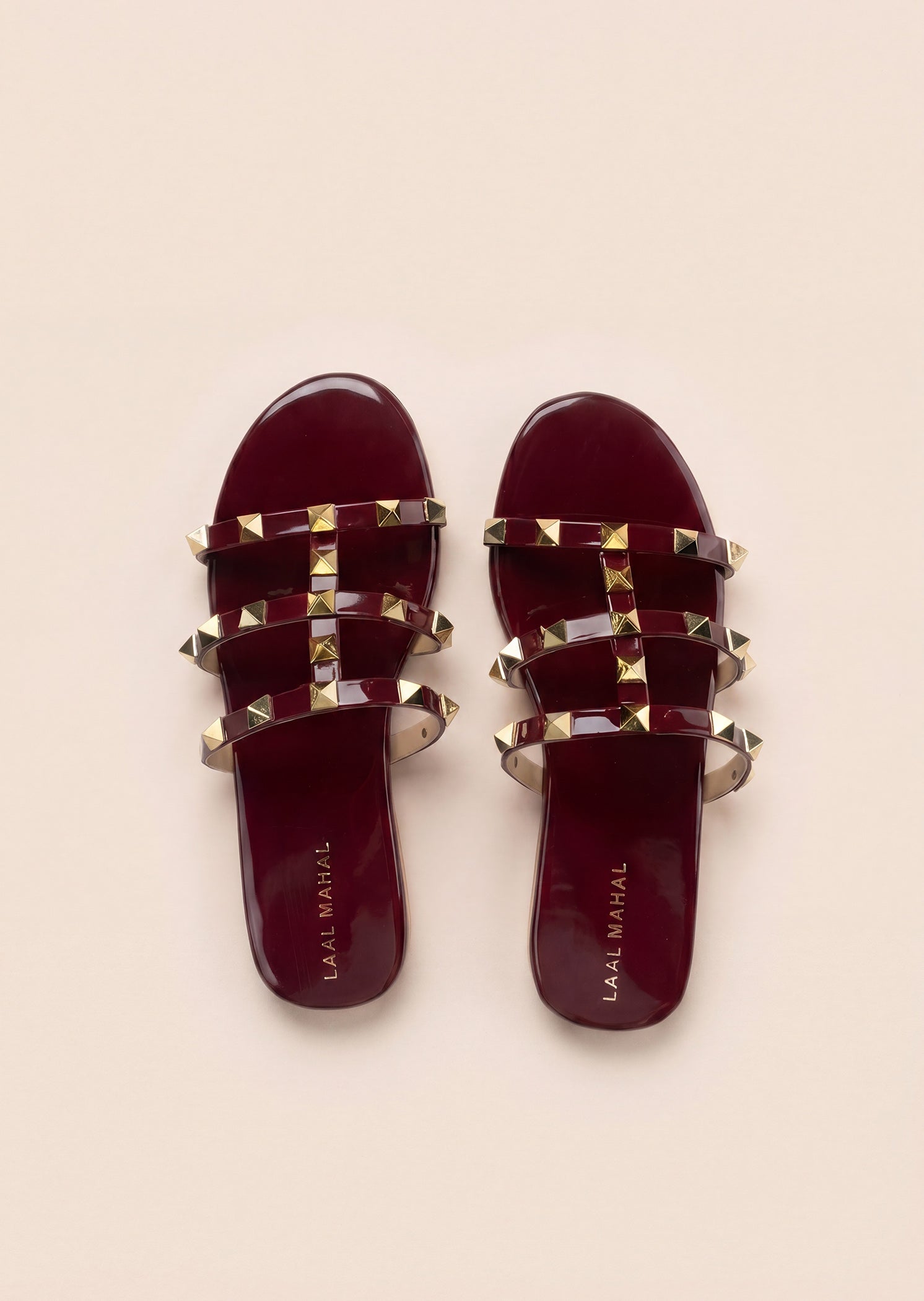 Burgundy rockstud flat slides flat lay white background Pakistan — Laal Mahal