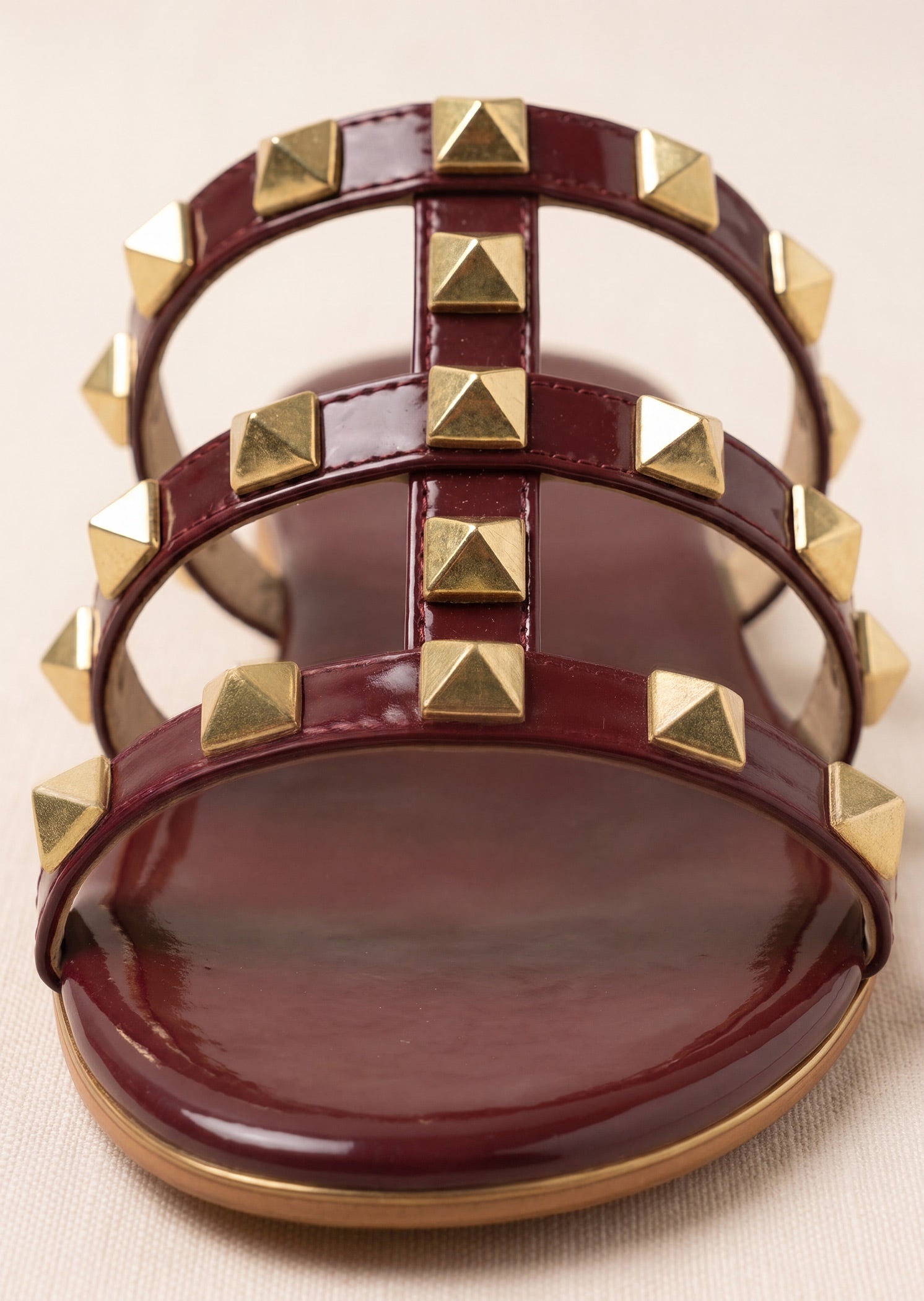 Burgundy rockstud flat slides front view gold pyramid studs multi-strap Pakistan — Laal Mahal