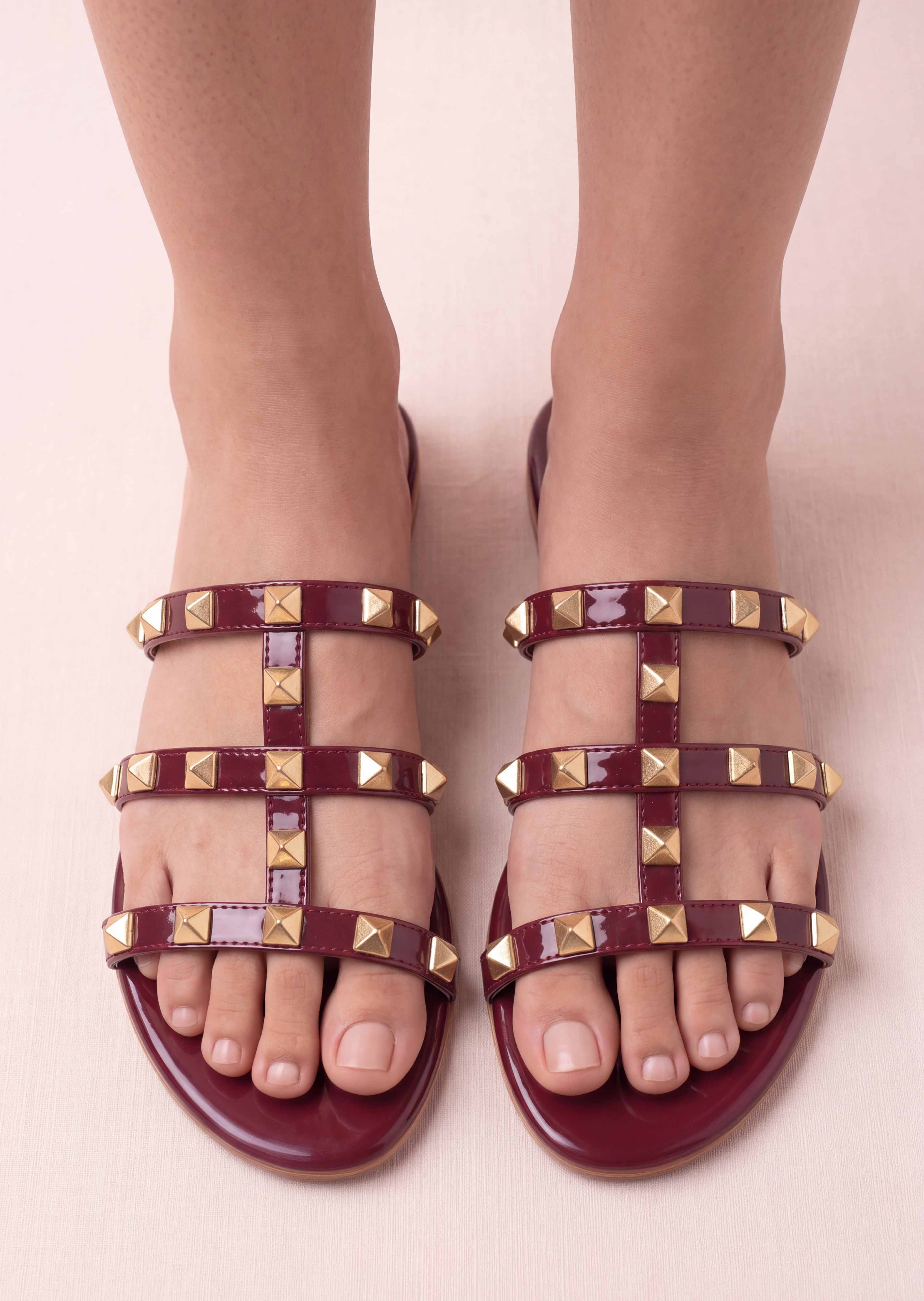 Burgundy rockstud flat slides worn front view Pakistan — Laal Mahal