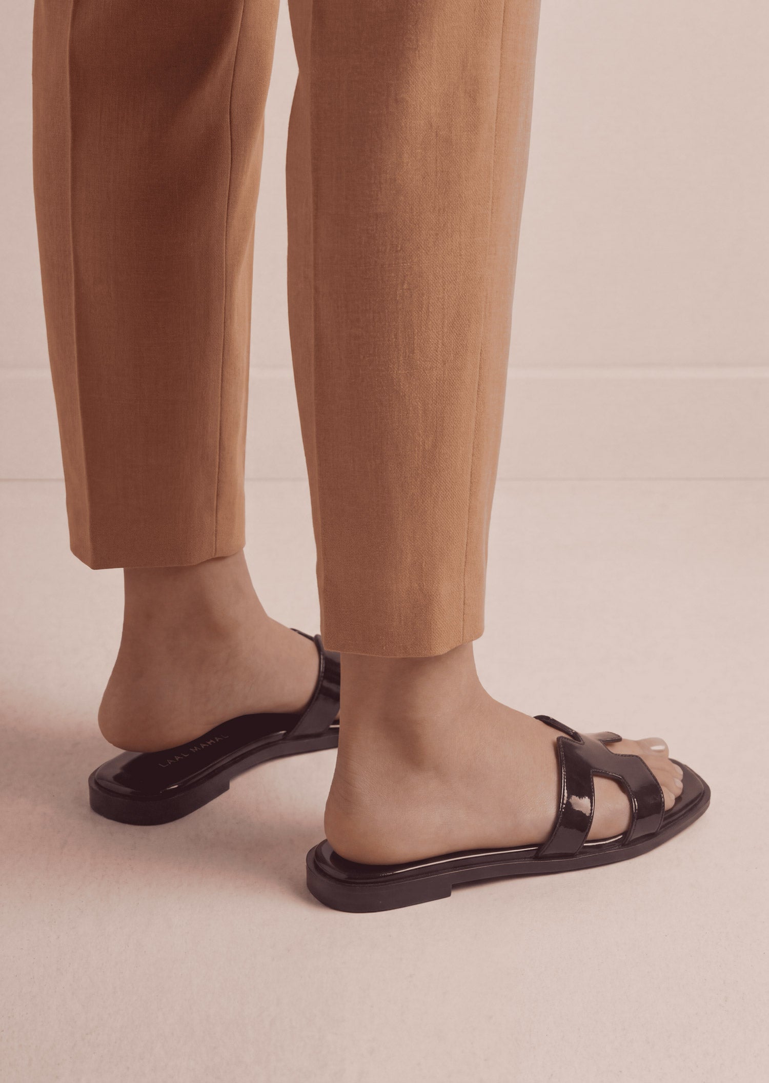 Glossy Black patent H-strap slide flat sandals on feet side view women Pakistan – Laal Mahal