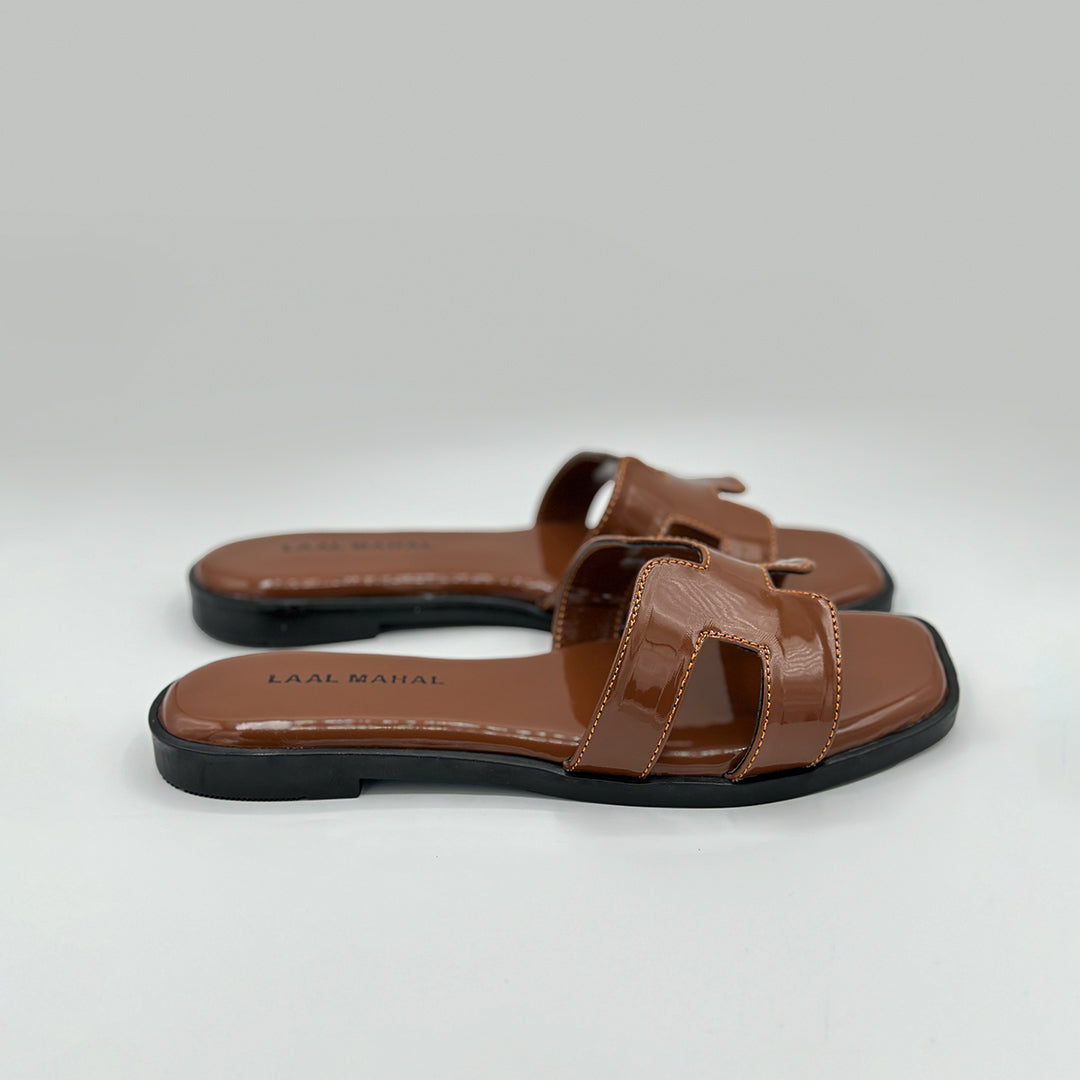 Hazel Hue caramel patent slide flat sandals angled pair view women Pakistan – Laal Mahal