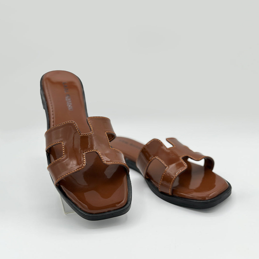 Hazel Hue tan patent leather H-strap slide flats pair on white background Pakistan – Laal Mahal