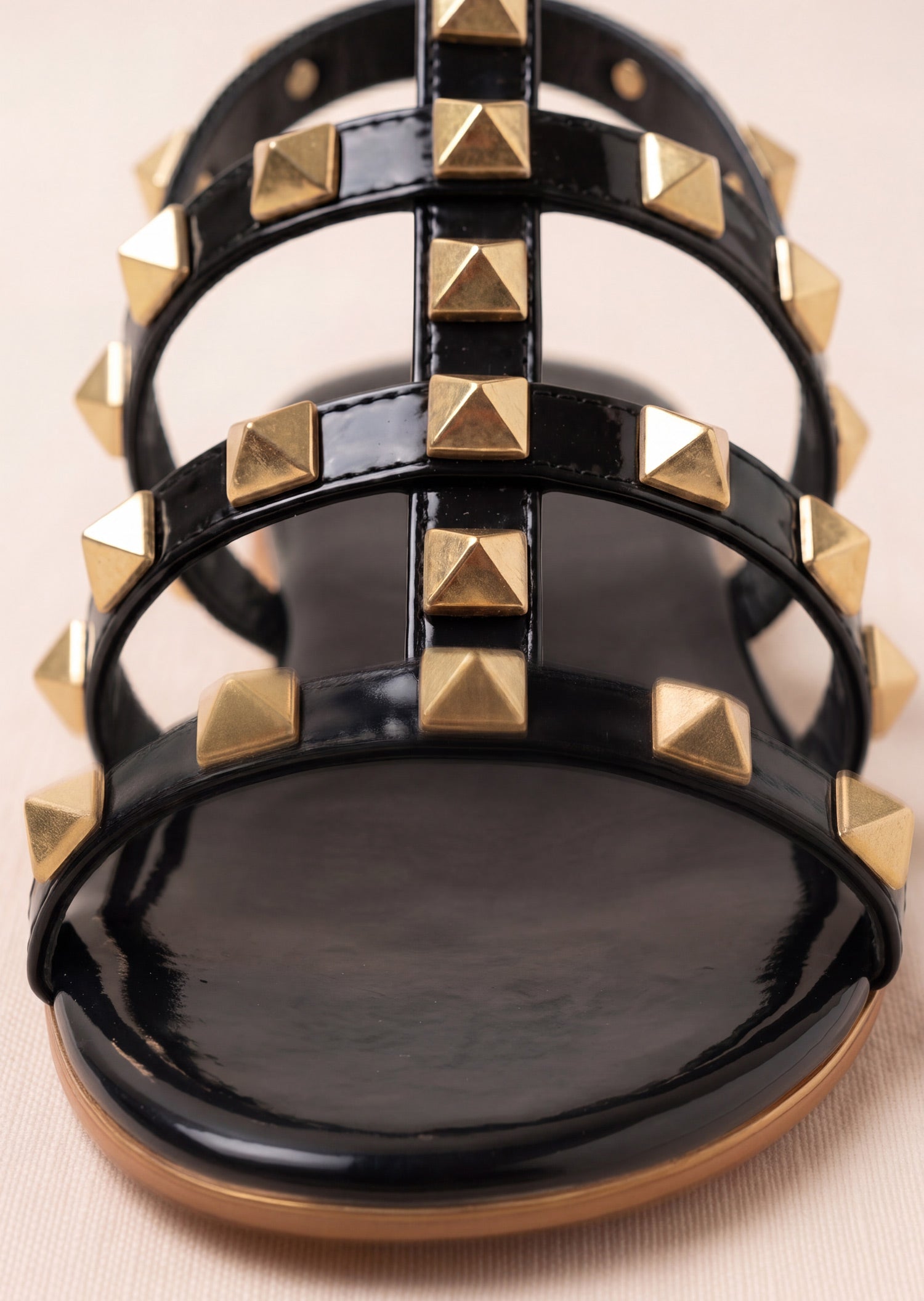 Laal Mahal Rockstud Flat Slide Sandals black patent front close-up showing gold pyramid studs on triple straps