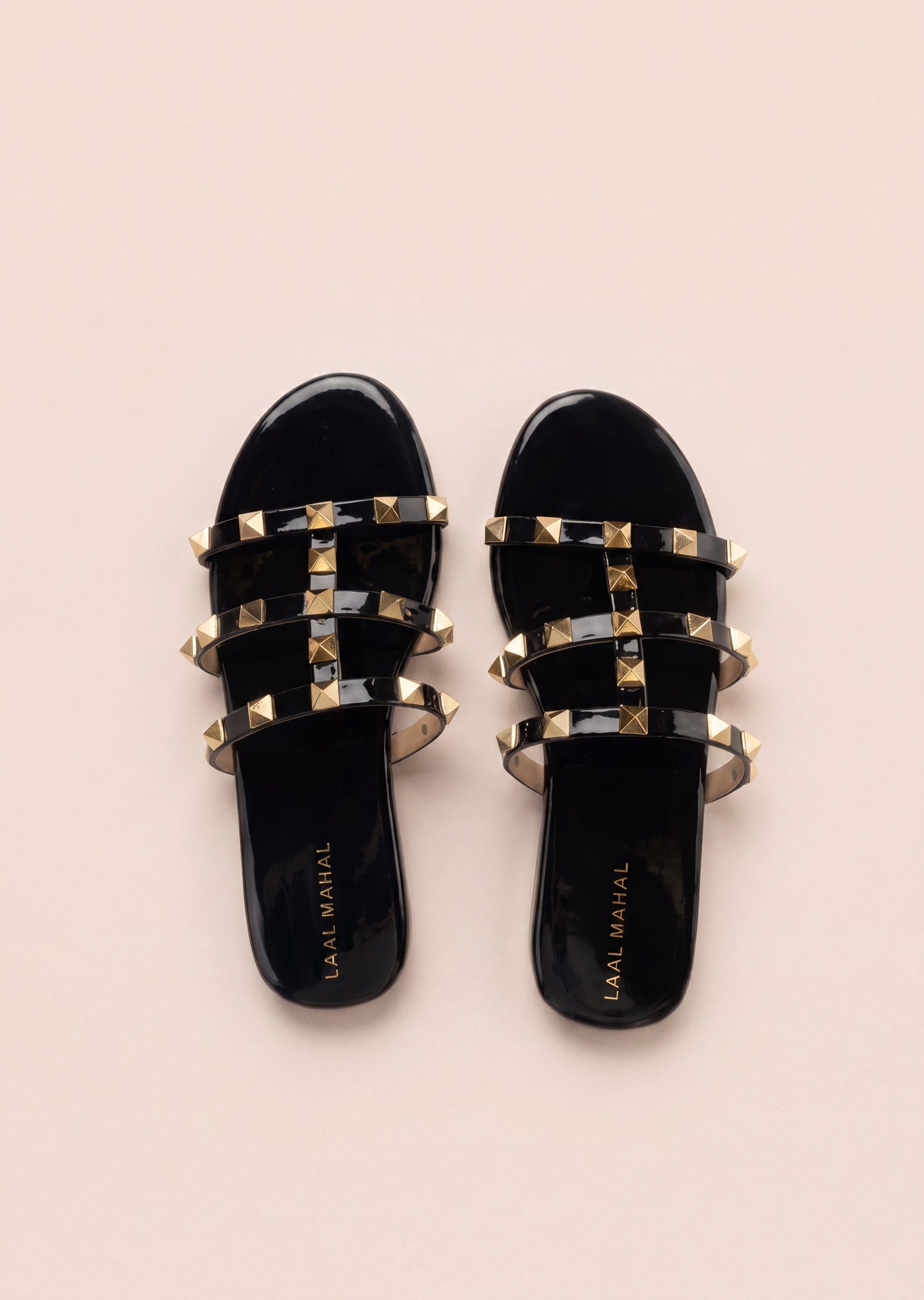 Laal Mahal Rockstud Flat Slide Sandals black top view showing branded insole and gold pyramid stud triple straps