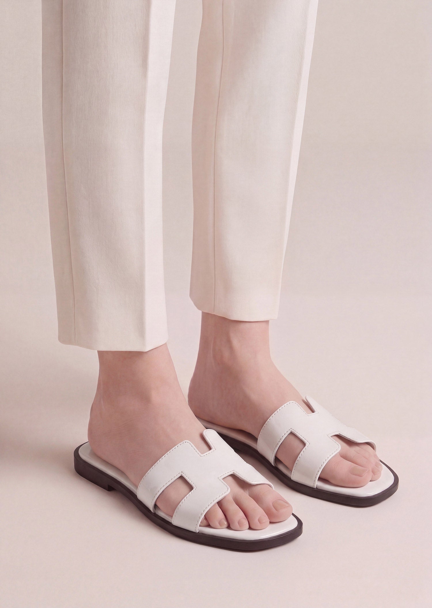 Pearla white patent H-strap slide flat sandals on feet women Pakistan – Laal Mahal