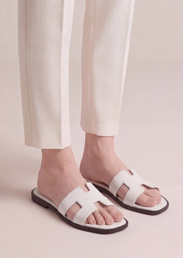 Pearla white patent H-strap slide flat sandals on feet women Pakistan – Laal Mahal