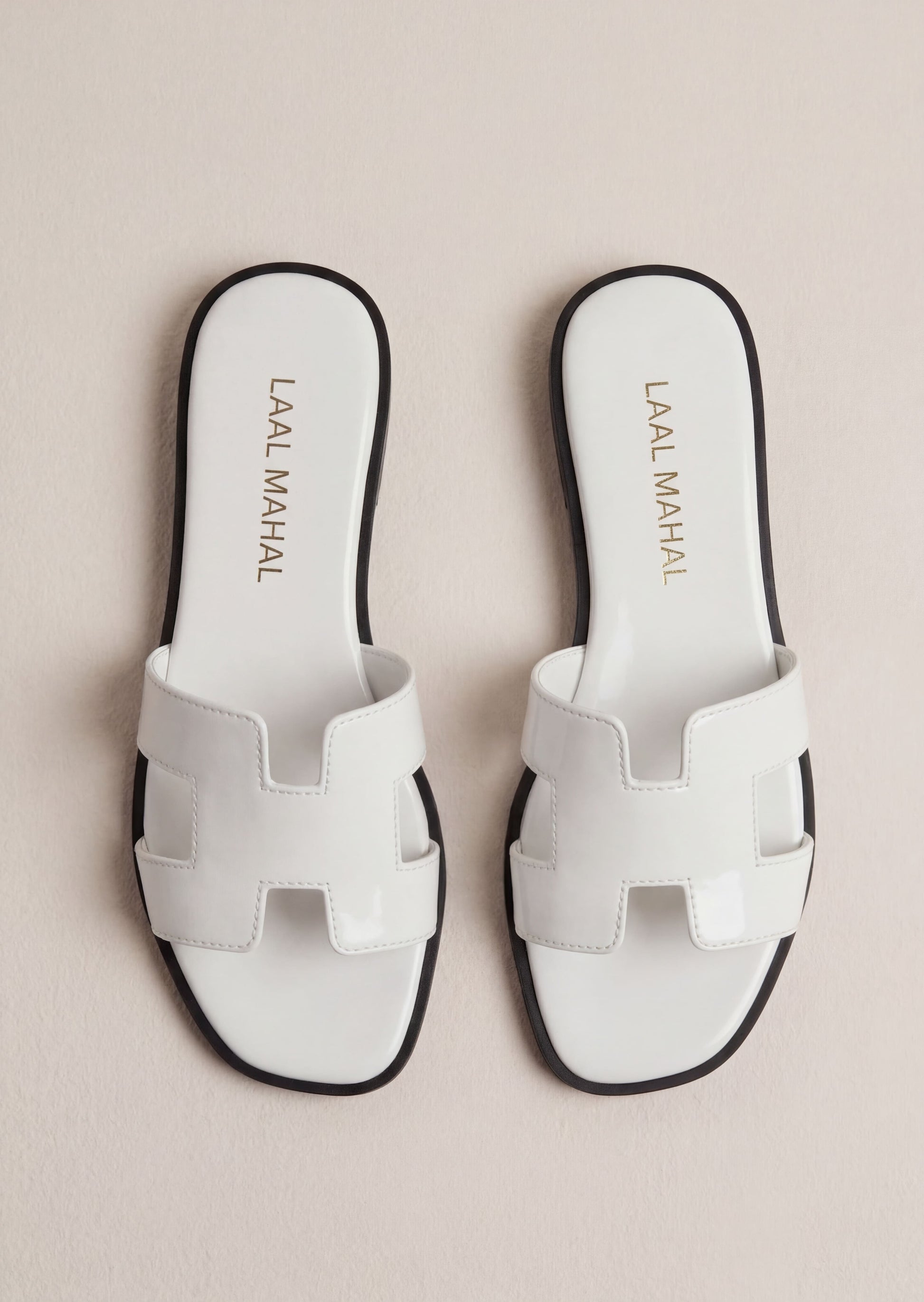 Pearla white patent H-strap slide flat sandals pair flat lay Pakistan – Laal Mahal