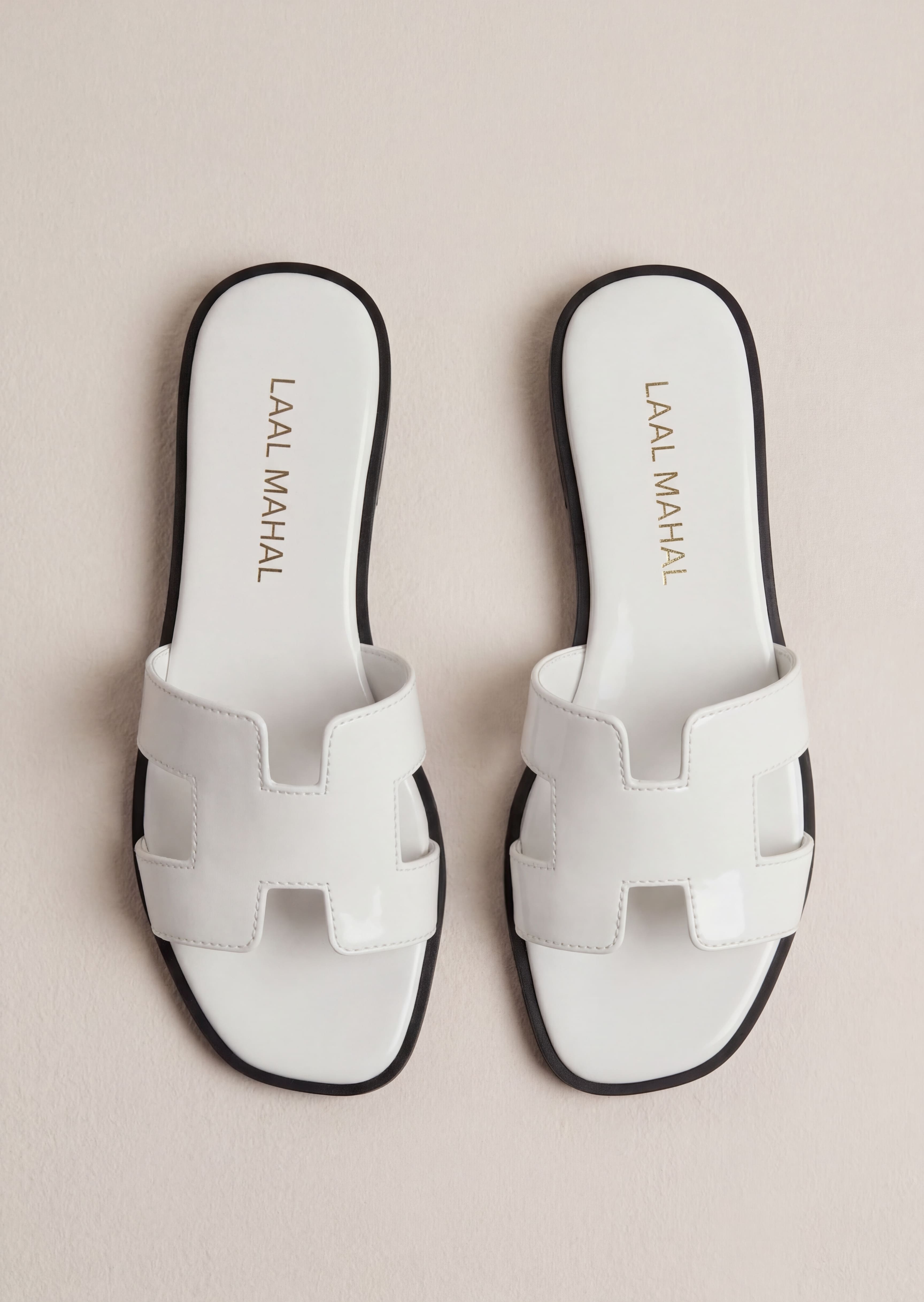 Pearla white patent H-strap slide flat sandals pair flat lay Pakistan – Laal Mahal