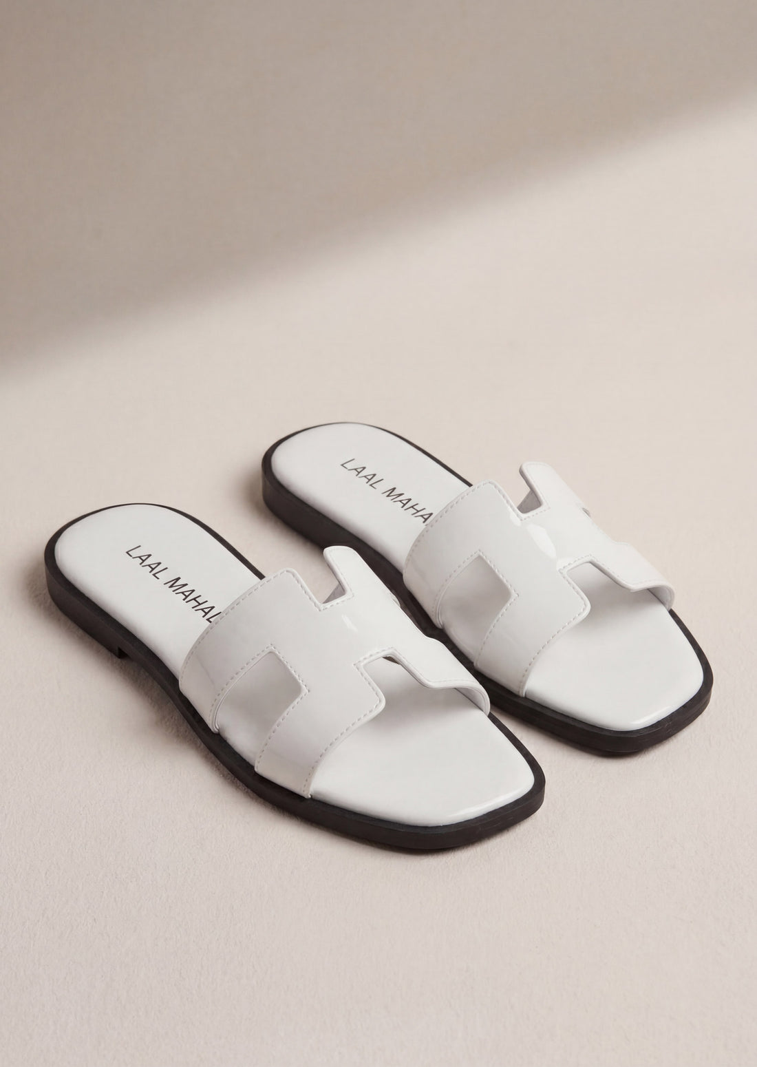 Pearla white patent H-strap slide flat sandals on feet women Pakistan – Laal Mahal