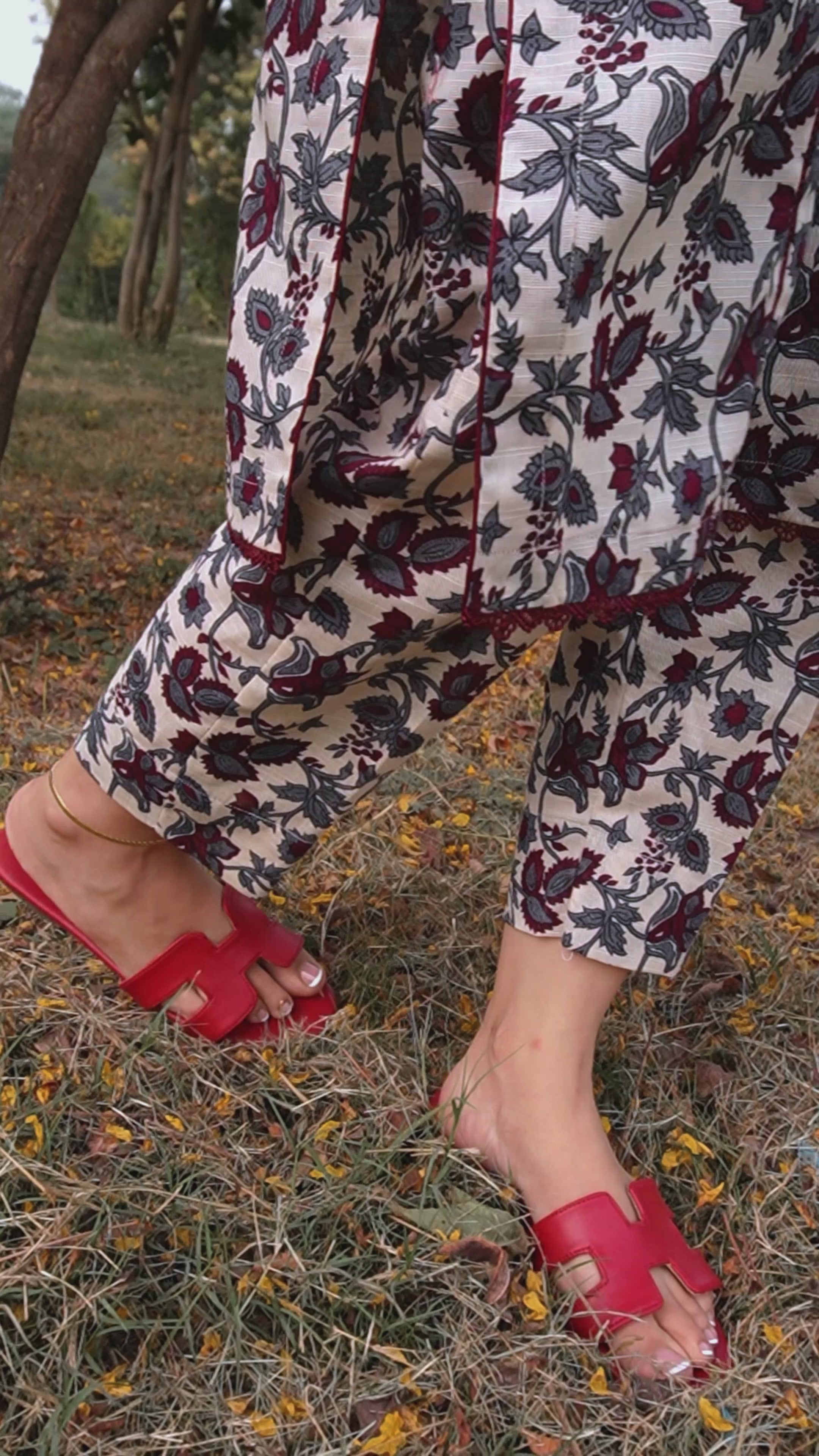 Lifestyle video featuring red H-style flat sandals from Laal Mahal, highlighting their elegant cut-out design and comfort during outdoor movement